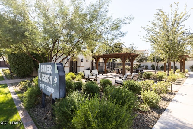 surrounding community featuring a gazebo, fence, and a patio