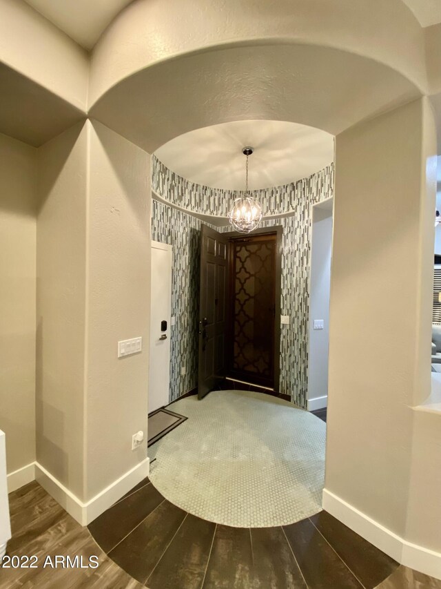 2042 W Periwinkle Way, Chandler, AZ 85248 - hallway with wood finished floors, a chandelier, baseboards, and arched walkways
