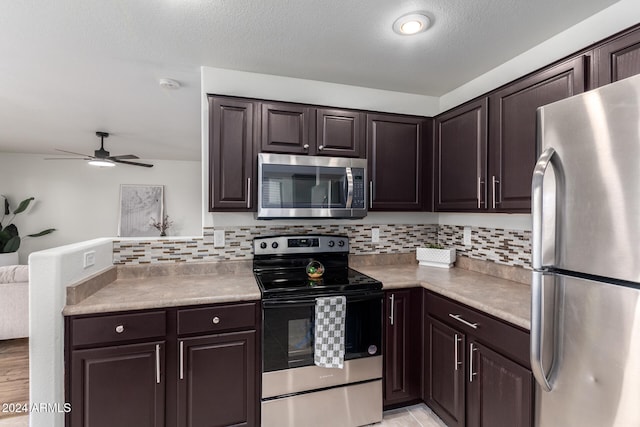 kitchen with decorative backsplash, dark brown cabinets, and stainless steel appliances