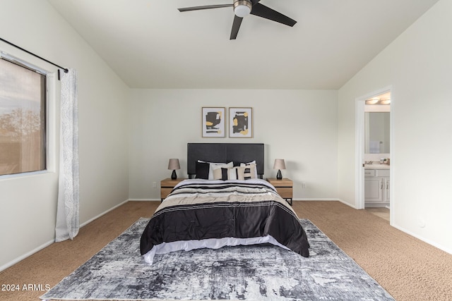 carpeted bedroom featuring ensuite bathroom, ceiling fan, and lofted ceiling