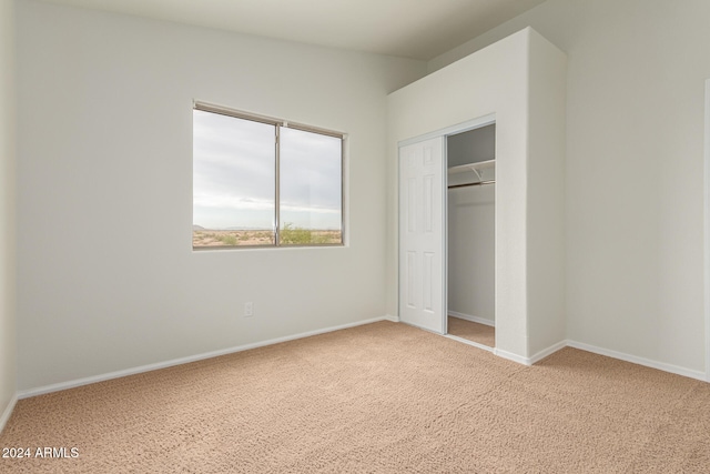 unfurnished bedroom with a closet and carpet floors