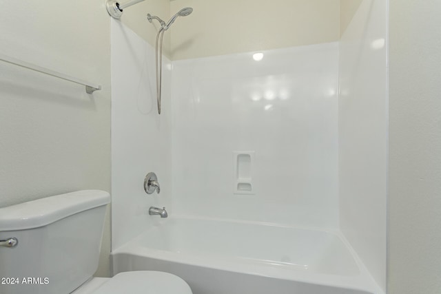 bathroom featuring shower / washtub combination and toilet