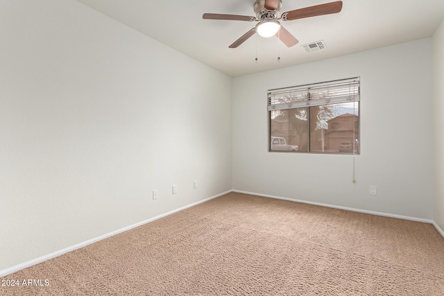 carpeted spare room featuring ceiling fan