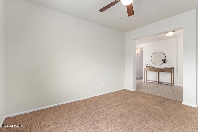 empty room featuring light colored carpet and ceiling fan