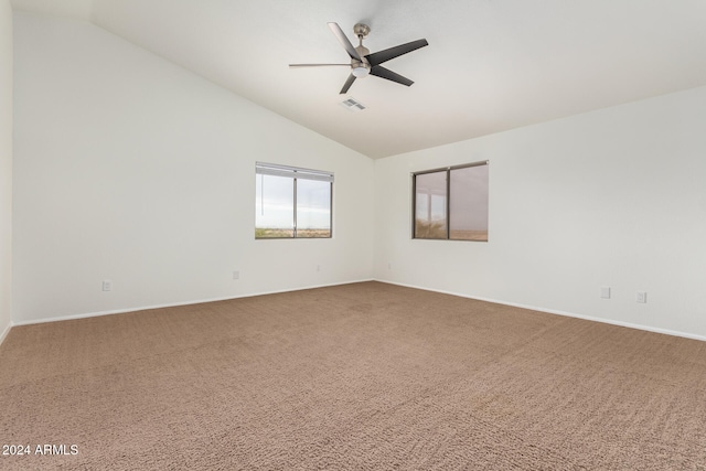 carpeted empty room with ceiling fan and vaulted ceiling