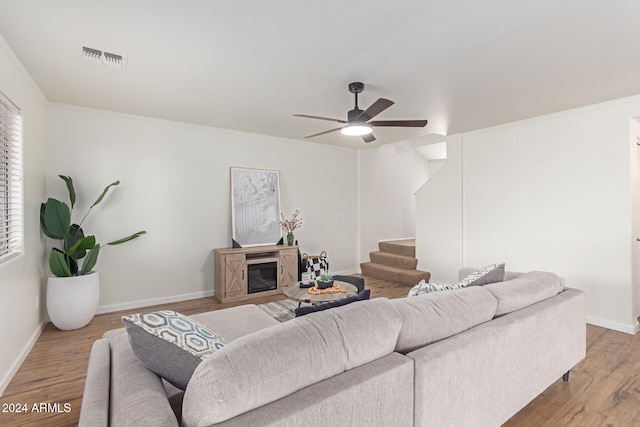 living room featuring ceiling fan and light hardwood / wood-style floors