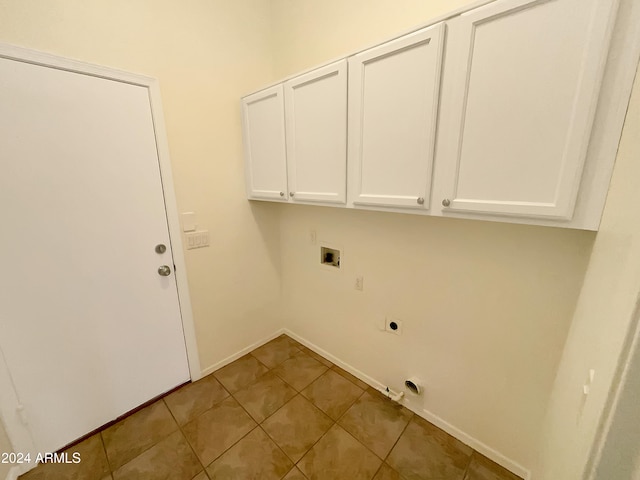 washroom with washer hookup, electric dryer hookup, cabinets, and light tile patterned floors