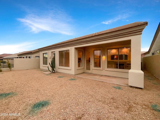 rear view of property featuring a patio