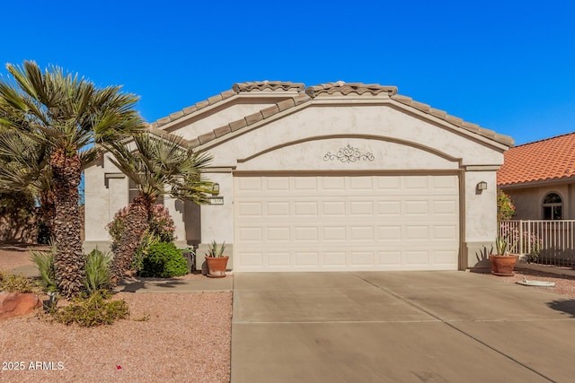 mediterranean / spanish-style home with a garage