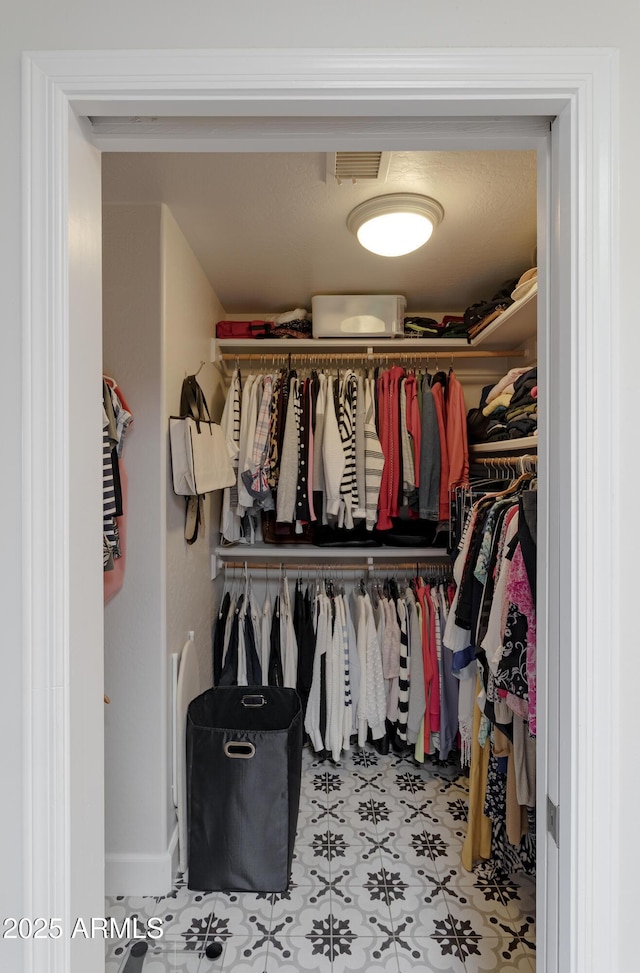 walk in closet featuring light floors and visible vents