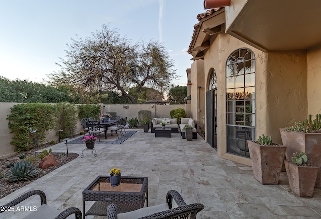 view of patio / terrace featuring outdoor dining space, a fenced backyard, and an outdoor living space