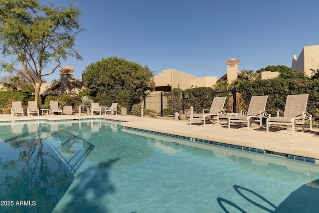 pool featuring a patio area and fence