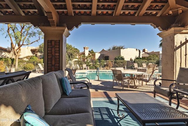 view of patio with a community pool and an outdoor living space