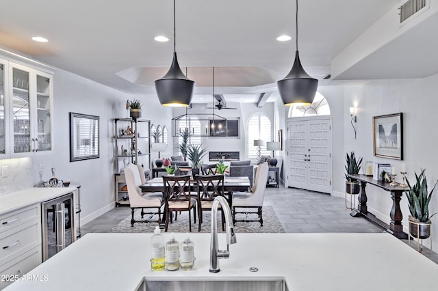 dining space with recessed lighting, beverage cooler, and visible vents