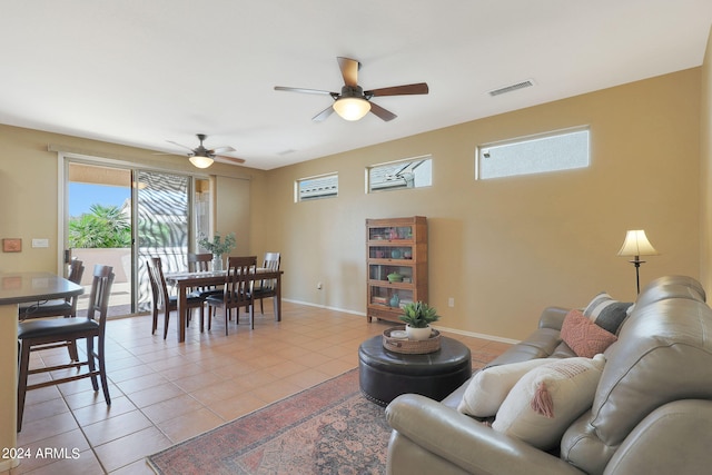 living room featuring light tile patterned floors and ceiling fan