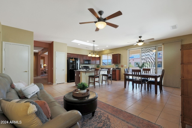 living room with ceiling fan and light tile patterned flooring