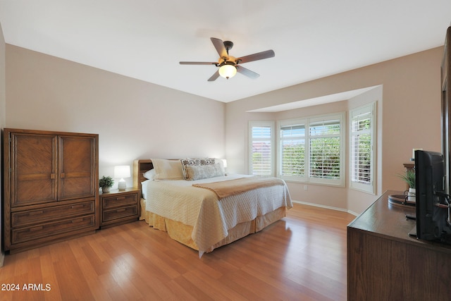 bedroom with ceiling fan and light hardwood / wood-style flooring