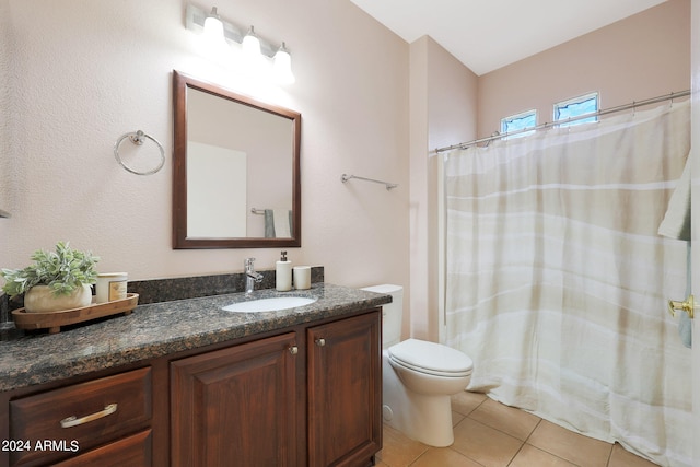 bathroom featuring curtained shower, tile patterned flooring, vanity, and toilet