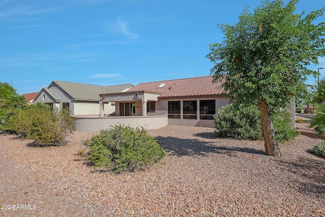 rear view of house with a sunroom