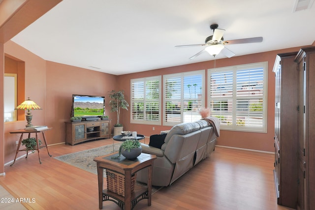 living room with ceiling fan and light wood-type flooring