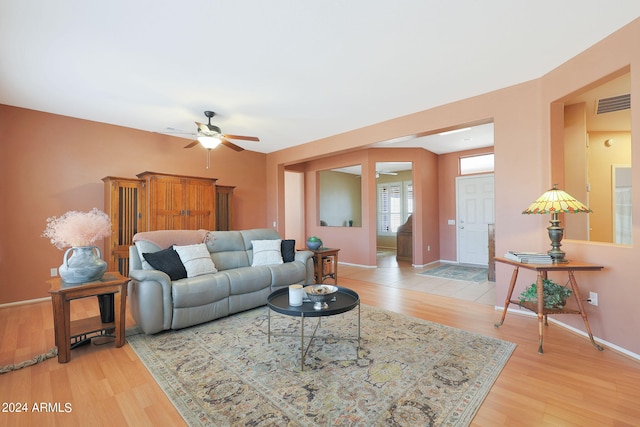 living room with wood-type flooring and ceiling fan