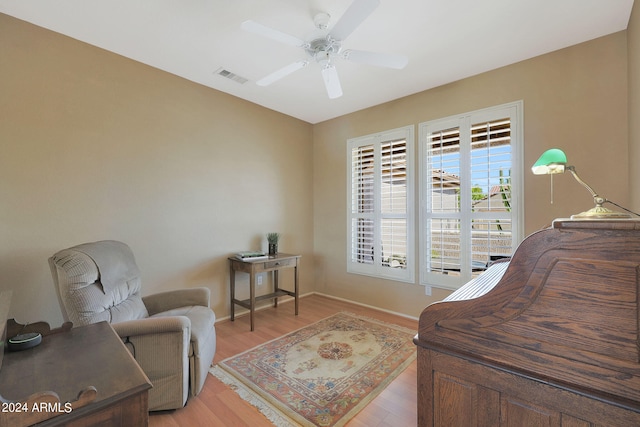 office space with ceiling fan and light hardwood / wood-style floors