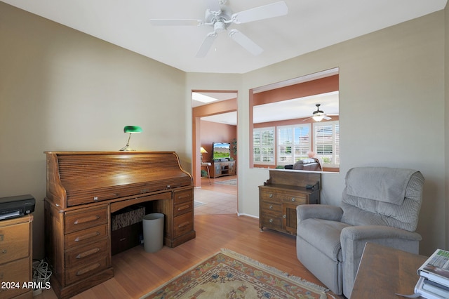 office space with light hardwood / wood-style floors and ceiling fan