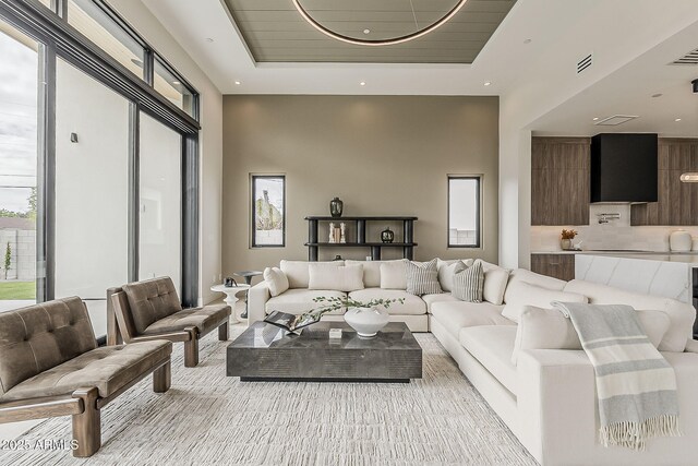 4414 N 29th St, Phoenix, AZ 85016 - living room with a tray ceiling, a towering ceiling, and light colored carpet