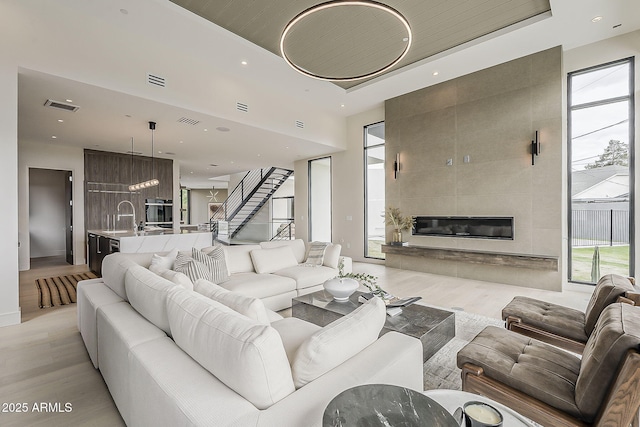 4414 N 29th St, Phoenix, AZ 85016 - living area featuring light wood-style floors, plenty of natural light, stairs, a fireplace, and recessed lighting