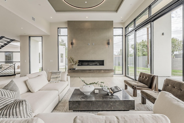 4414 N 29th St, Phoenix, AZ 85016 - living room featuring a tray ceiling and a tile fireplace