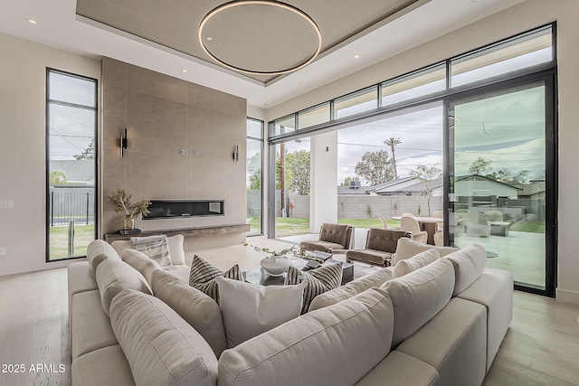 4414 N 29th St, Phoenix, AZ 85016 - living room featuring a raised ceiling, light wood-style floors, recessed lighting, baseboards, and a high ceiling
