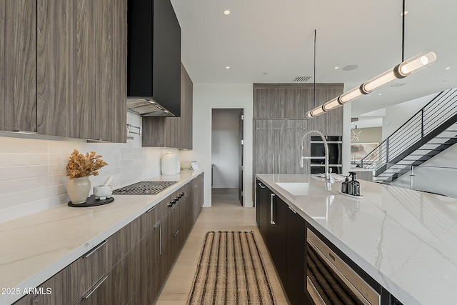 4414 N 29th St, Phoenix, AZ 85016 - kitchen with modern cabinets, decorative backsplash, a sink, pendant lighting, and light wood-style flooring
