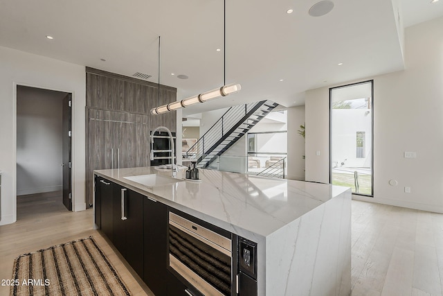 4414 N 29th St, Phoenix, AZ 85016 - kitchen with modern cabinets, light wood-type flooring, stainless steel microwave, a spacious island, and recessed lighting