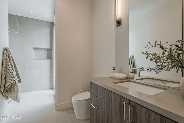 4414 N 29th St, Phoenix, AZ 85016 - bathroom featuring vanity, toilet, tiled shower, tile patterned floors, and baseboards