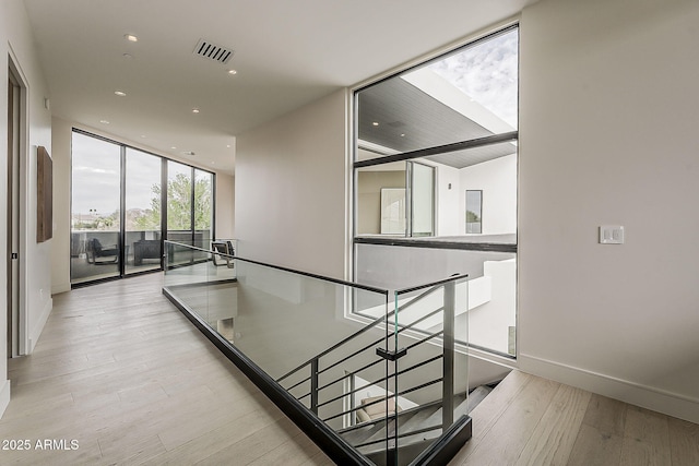 4414 N 29th St, Phoenix, AZ 85016 - staircase with wood finished floors, a wall of windows, recessed lighting, and baseboards