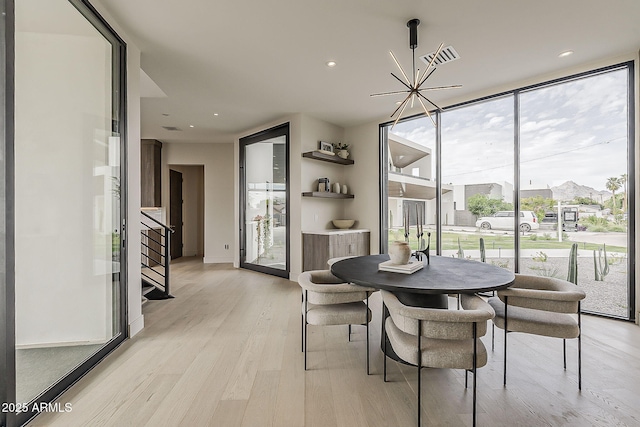 4414 N 29th St, Phoenix, AZ 85016 - dining area with light wood-type flooring, stairs, a chandelier, floor to ceiling windows, and recessed lighting