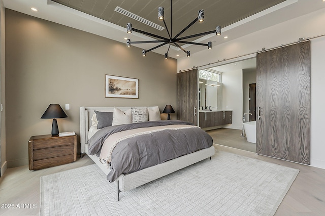 4414 N 29th St, Phoenix, AZ 85016 - bedroom with a barn door, a raised ceiling, baseboards, recessed lighting, and ensuite bath