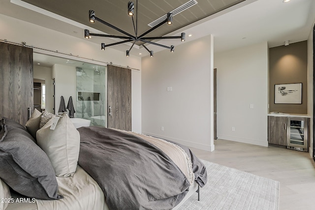 4414 N 29th St, Phoenix, AZ 85016 - bedroom featuring a barn door, light wood-type flooring, recessed lighting, beverage cooler, and baseboards