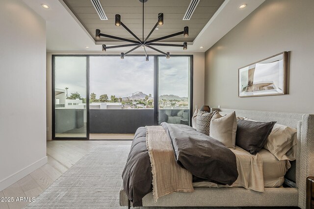 4414 N 29th St, Phoenix, AZ 85016 - bedroom featuring access to outside, a chandelier, wood finished floors, recessed lighting, and baseboards