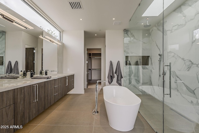 4414 N 29th St, Phoenix, AZ 85016 - bathroom featuring a marble finish shower, double vanity, a soaking tub, a walk in closet, and recessed lighting