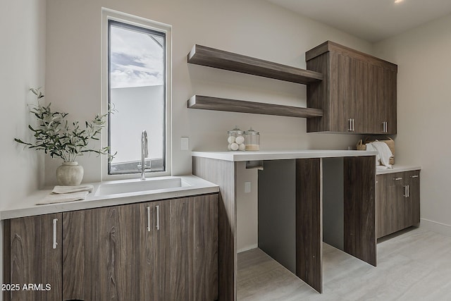 4414 N 29th St, Phoenix, AZ 85016 - kitchen with open shelves, a sink, light wood-style flooring, and light countertops