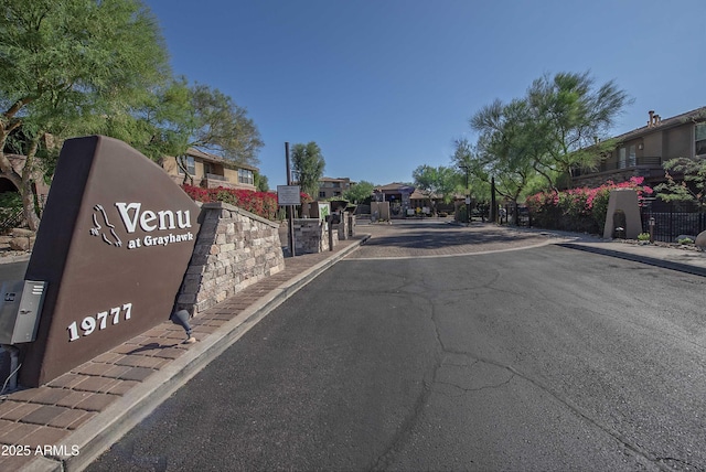 19777 N 76th St Unit 2142, Scottsdale, AZ 85255 - view of asphalt street with curbs, sidewalks, a gated entry, and a residential view
