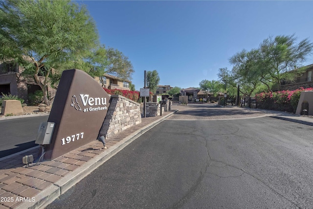 19777 N 76th St Unit 2142, Scottsdale, AZ 85255 - view of asphalt road featuring curbs, a gated entry, sidewalks, and a residential view