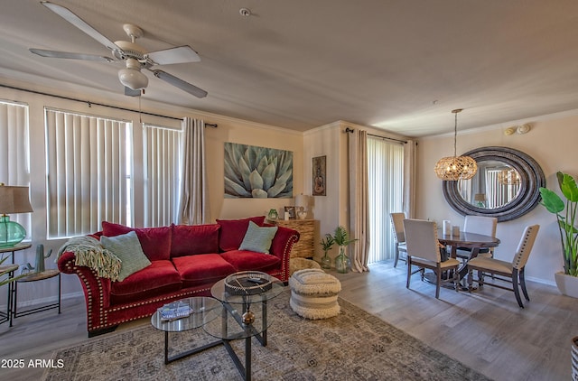 19777 N 76th St Unit 2142, Scottsdale, AZ 85255 - living room featuring wood finished floors, a ceiling fan, ornamental molding, and a chandelier