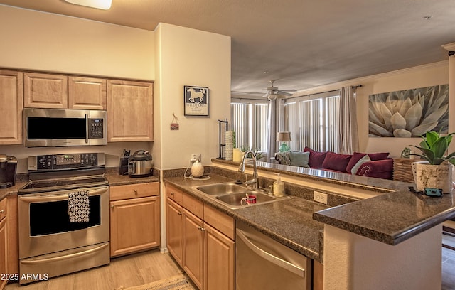 19777 N 76th St Unit 2142, Scottsdale, AZ 85255 - kitchen with stainless steel appliances, a peninsula, open floor plan, dark countertops, and ornamental molding