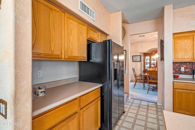 kitchen featuring black refrigerator with ice dispenser