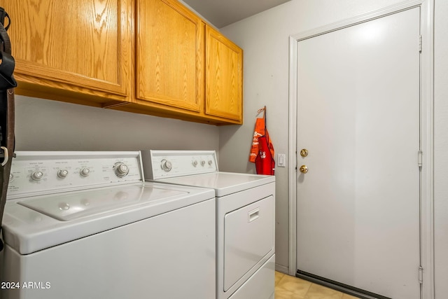 washroom with cabinets and separate washer and dryer