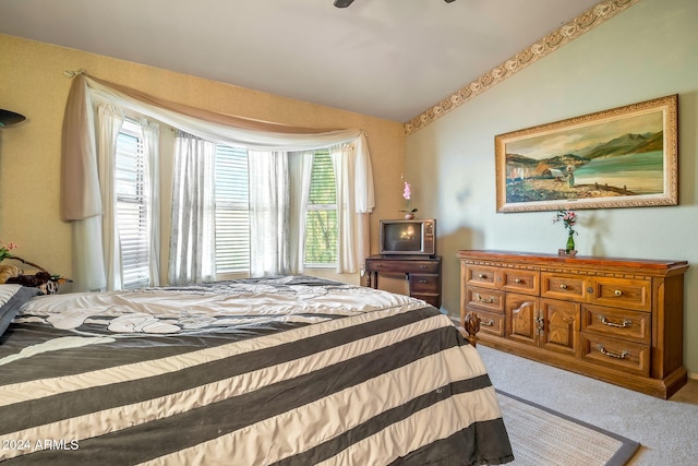 carpeted bedroom featuring vaulted ceiling