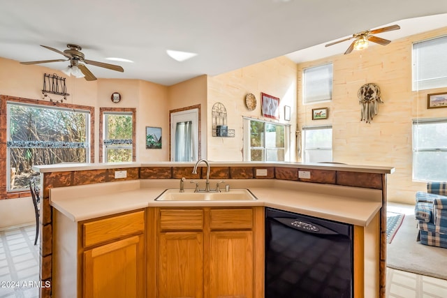 kitchen featuring dishwasher, ceiling fan, and sink