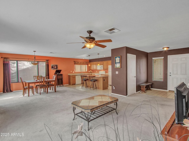 carpeted living room featuring ceiling fan